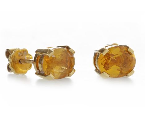 PAIR OF GEM SET STUD EARRINGSeach set with an oval stone with orange tone 9.1mm long, with THOMPSON to the reverse and marked