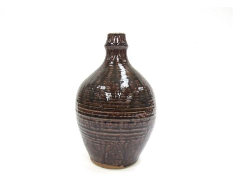 DAVID LEACH (1911-2005) A studio pottery bottle vase with a thin tenmoku glaze. Impressed personal seal. 27cm high 