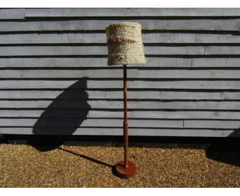 A Danish turned teak standard lamp with original wool shade 