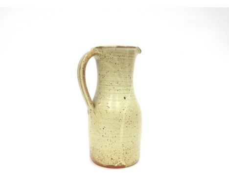 A Winchcombe Pottery tall jug with oatmeal glaze. Impressed seal. 28cm high 