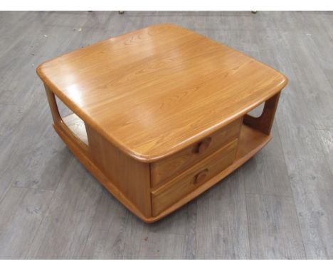 An Ercol 'Pandora's Box' coffee table in light Elm finish. 81.5cm x 80cm x 40cm high 