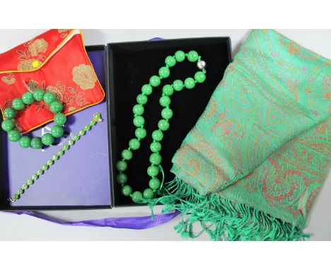 A Modern Burmese Green Jade Bead Necklace, of uniform design, knotted to magnetic clasp, together with a similar bead bracele
