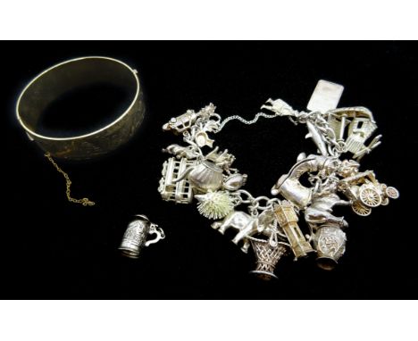 Heavy silver charm bracelet and a gold plated bangle Condition Report &amp; Further Details Bracelet approx 4.8oz