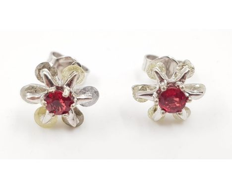 A pair of ruby and diamond flower earrings in 14ct white gold. 2.2g total weight. 