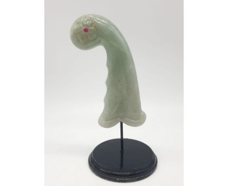 A Mughal, light green, carved jade hilt with two red stones (ruby?) on a custom made base. India 18th19th Century. Hilt dimen