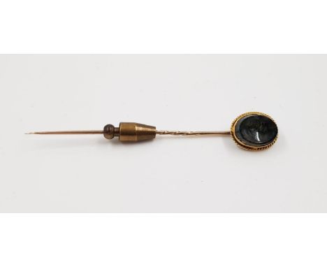 A yellow metal stick pin with agate head. Weighs 3.4g and is 7cm. 