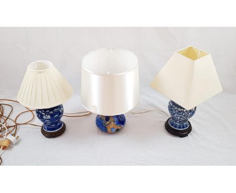 3 Ceramic table lamps with shades. Two are Chinese with a blue decorative glaze. The third is a Clews Ltd of England - a hand