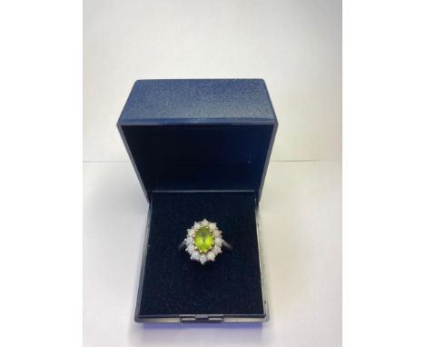 Silver ring having peridot centre stone and faux opal surround. Size P. 