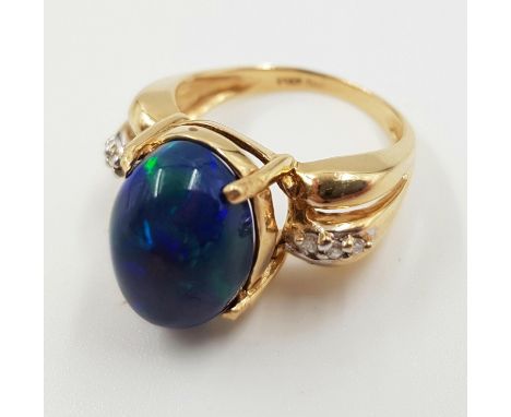 A 14ct gold, opal and diamond ring. 5g total weight and is size M. 