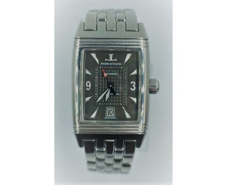 Jaeger-lecoultre Reverso watch with rectangular black face and steel strap. 