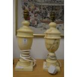 A pair of alabaster urn shaped table lamps.