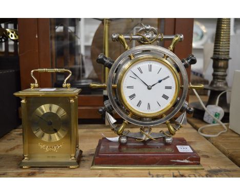 A mantel clock modelled as a ships wheel together with a modern brass carriage clock.