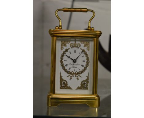 A brass carriage clock.