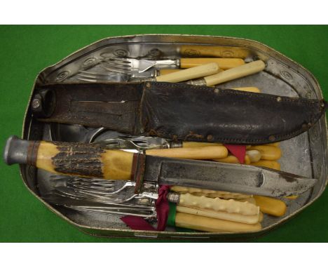 A sheath knife with antler handle and a quantity of flatware.