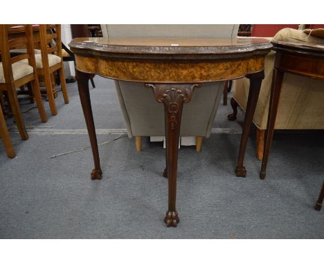 A good figured walnut shaped demi-lune fold-over card table on carved cabriole legs claw feet.