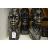 Three carved stone busts.