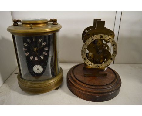 A reproduction brass carriage clock and a clock movement.