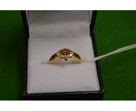 An unusual gold ruby and diamond ring.