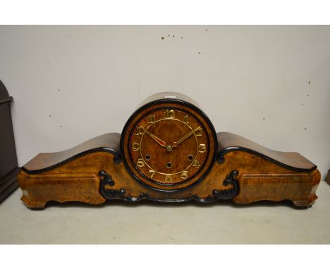 A stylish walnut cased mantel clock.