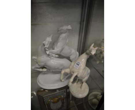German white porcelain model of a rearing horse together with a similar model of two horses.
