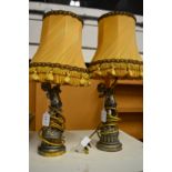 A pair of decorative cherub lamps.