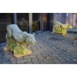 A good pair of reconstituted stone models of prowling lionesses on rocky outcrops.