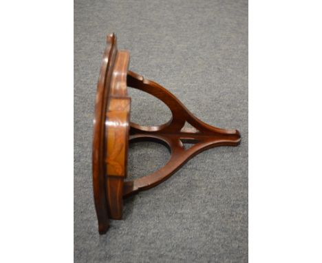 A small inlaid mahogany corner shelf.