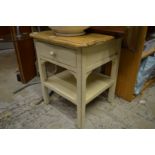 A painted bedside table.