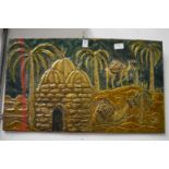 An Eastern embossed metal picture.
