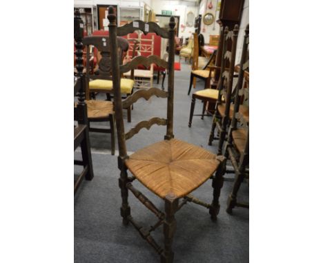 A set of six ladder back and rush seated dining chairs (faults).