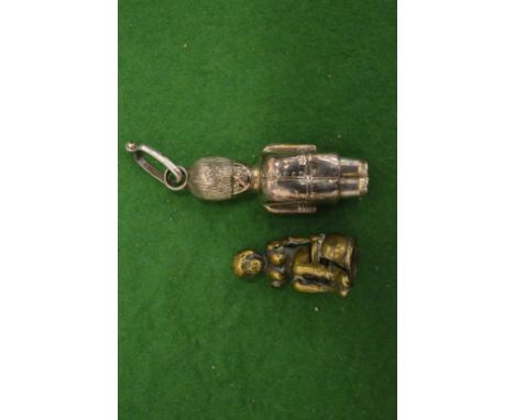 A novelty silver whistle and another item.