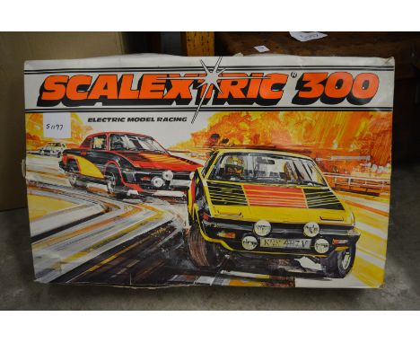 A Scalextric 300 boxed set (used) together with Hornby train accessories.