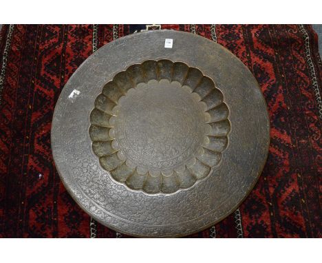 An Eastern finely engraved and enamel circular brass tray.