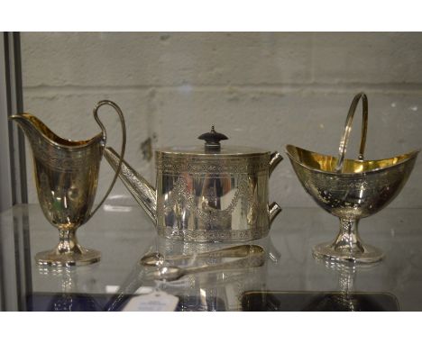 An early Victorian small silver teapot with pedestal sugar basin, helmet cream jug and a pair of sugar nips.