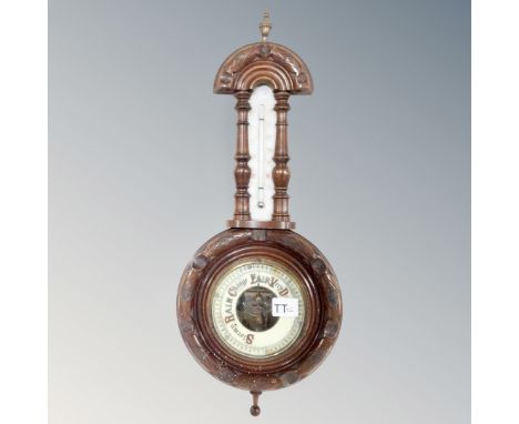 An antique carved wall barometer.