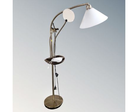A floor standing angle poise lamp with magnifier 