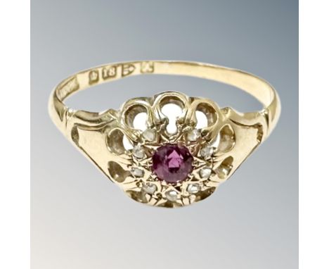 An 18ct gold ruby and diamond cluster ring, size R.  CONDITION REPORT: 2.8g. One diamond deficient. 