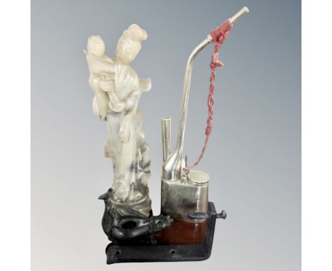 A Japanese carved polished stone figure together with an opium pipe and metal incense burner 