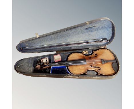 An early 20th century German violin labelled Copy of Antonio Stradivarius, two-piece 14" back, with bow in coffin case (af)