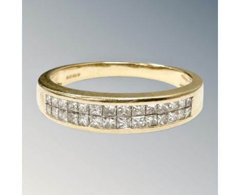 An 18ct gold princess-cut diamond half-eternity ring, size Q.  CONDITION REPORT: 4.6g. 