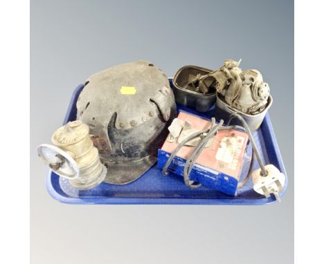 A vintage miner's helmet with carbide lamp Oldham charger and face mask in metal tin 