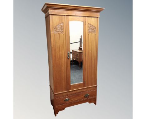 An Art Nouveau satin wood mirrored wardrobe fitted a drawer together with two drawer dressing chest 