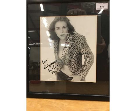 Signed portrait photograph of Elizabeth Hurley signed ' love Elizabeth Hurley ' in glazed frame