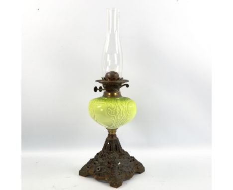 A Duplex oil lamp with moulded green glass vessel, on cast-iron base, height including shade 57cm 