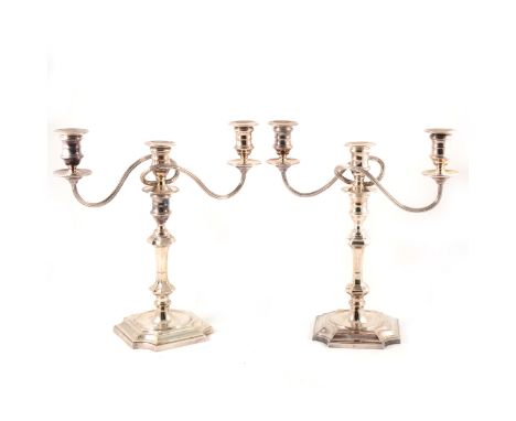 A pair of Georgian style silver three-light candelabra, Barker Ellis Silver Co, Birmingham, 1988, weighted, 34cm.
