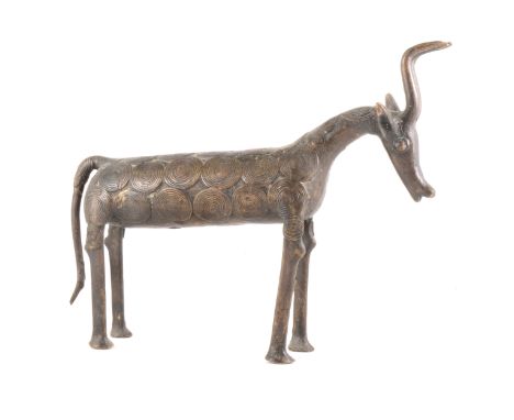 A bronze sulpture of a cow, probably African, 28cm.