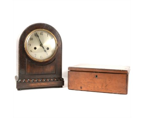 An oak cased mantel clock, silvered dial, movement striking on a gong, 31cm; and a stained wood slide box. (Qty: 2)