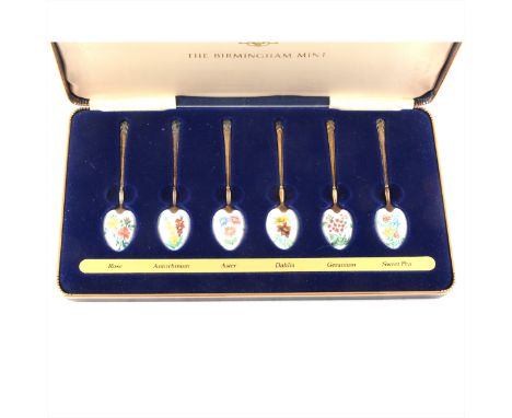 A set of six silver gilt teaspoons with flower enamelled bows. Fitted case, with certificate and purchase invoice. Birmingham