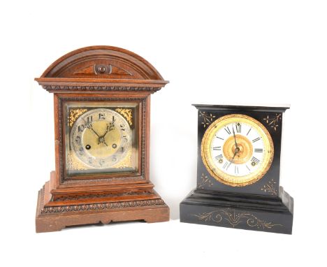 A German oak cased mantel clock, silvered dial, movement by Jungens, striking on two gongs, 38cm; American black metal mantel