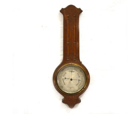 A 1930s oak cased banjo barometer, signed Negretti &amp; Zambra, R9779, circular silvered dial, height 60cm.